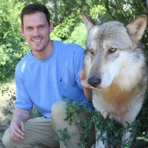 A picture of me next to a wolf at Seacrest Wolf Preserve